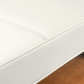 Close-up of white PU leather upholstery with stitched seam on Avanora massage table