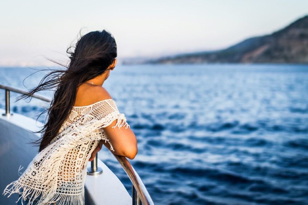 woman on a boat gazing at the sea
