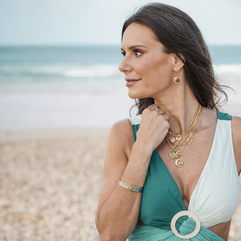 woman on beach wearing jewelry