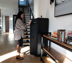 Vaultek NRS800i-BK Smart Safe – lifestyle image with homeowner opening the safe
