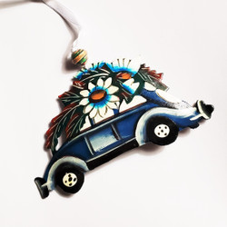 Recycled steel drum car carrying Christmas tree ornament from Haiti