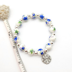 fair trade olive wood and ceramic floral bead bracelet with Jerusalem cross bead from the Holyland