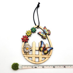 Fair trade eucalyptus wood ornament with butterflies from Chile