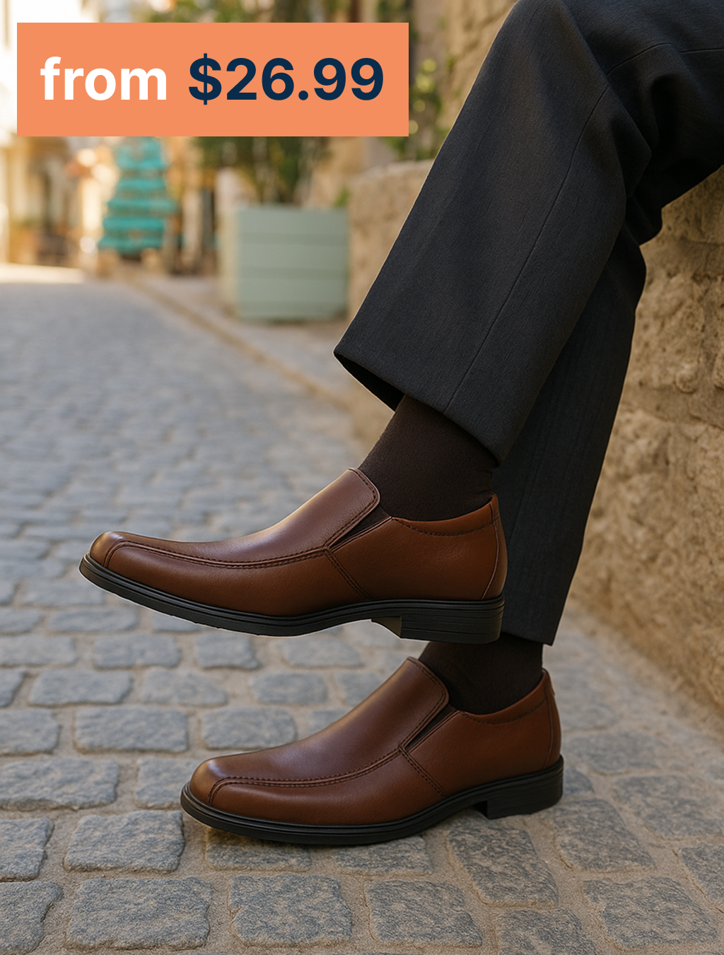 Men is sitting in the street wearing brown Fabso Shoes slip-ons