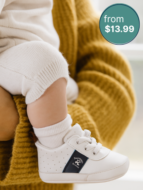 Men is sitting in the street wearing brown Fabso Shoes slip-ons