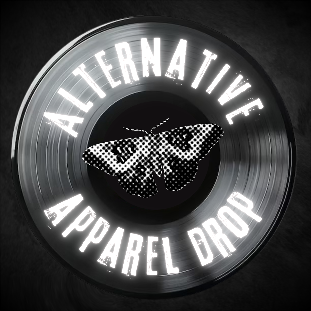 Black-and-white photograph of a vinyl record with the words “Alternative Apparel Drop” printed around the record and a butterfly graphic in the center.