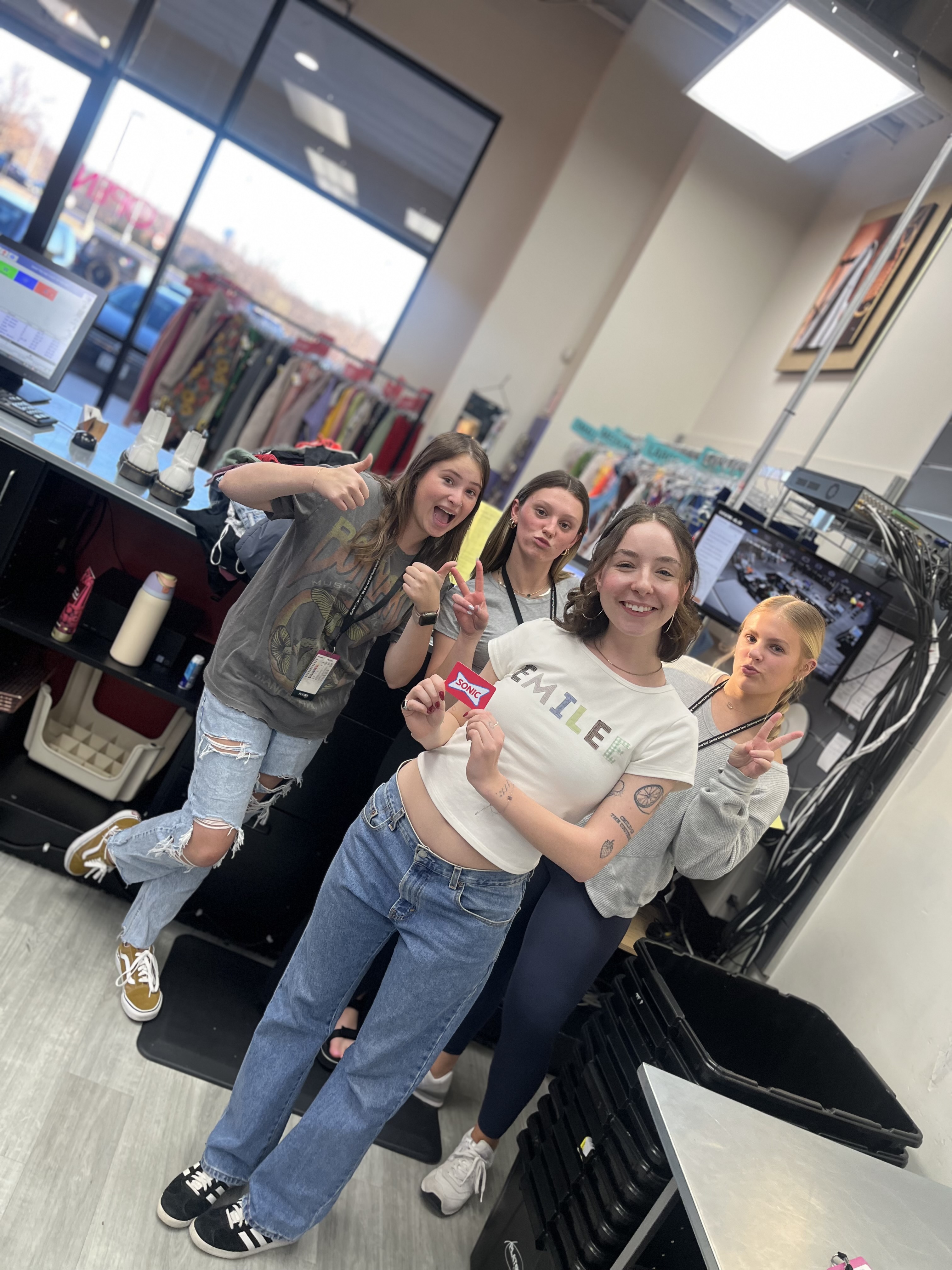 picture of smiling staff members behind sales counter