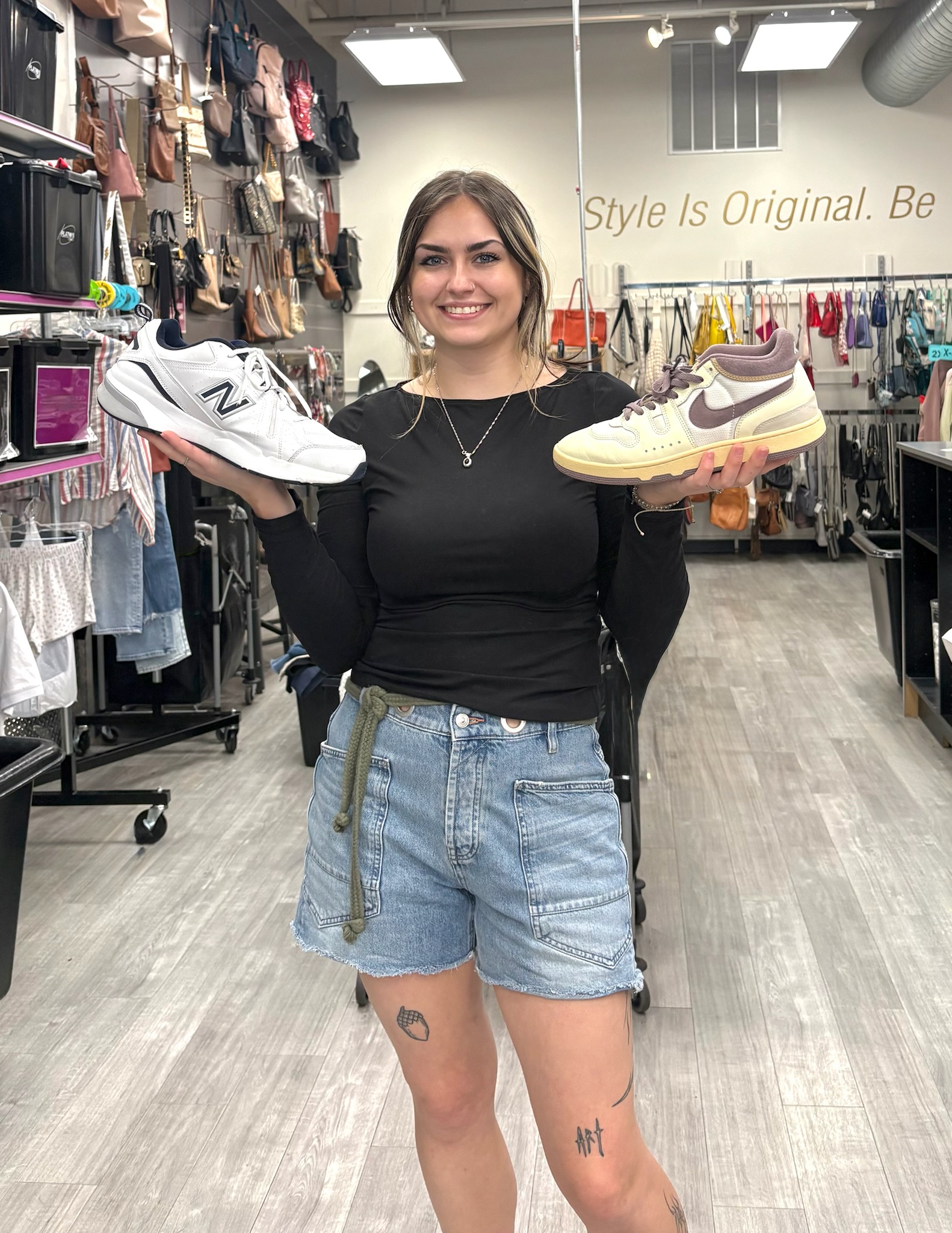 Smiling employee holding sneakers