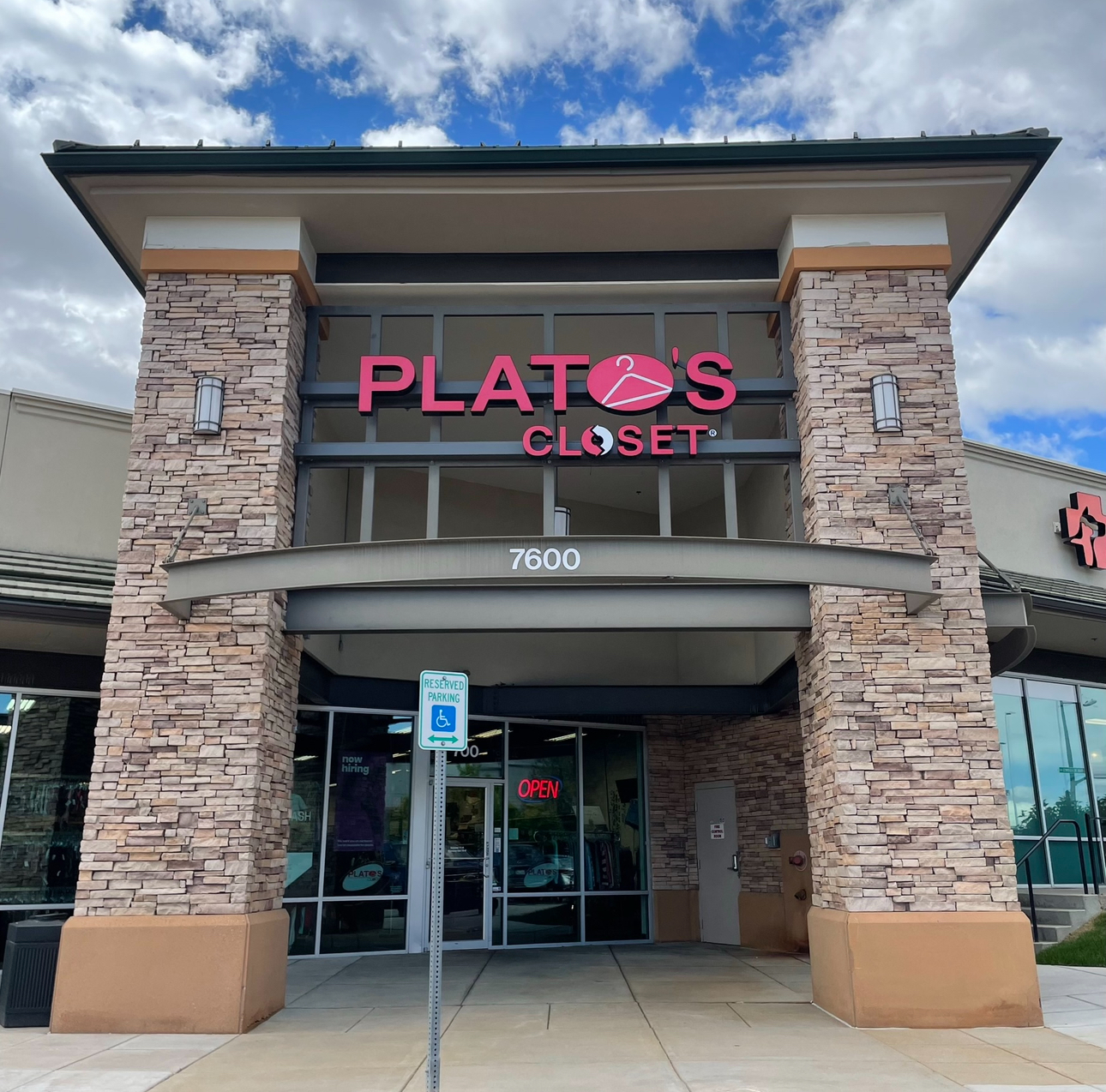 A Plato's Closet Storefront in front of beautiful blue skies.