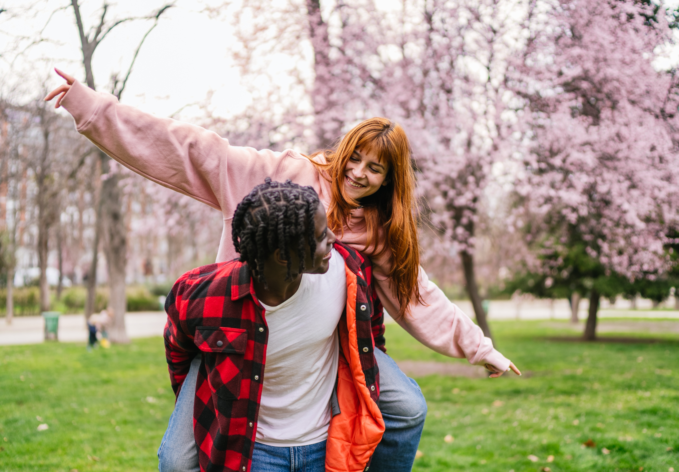 Guy giving girl piggy back ride
