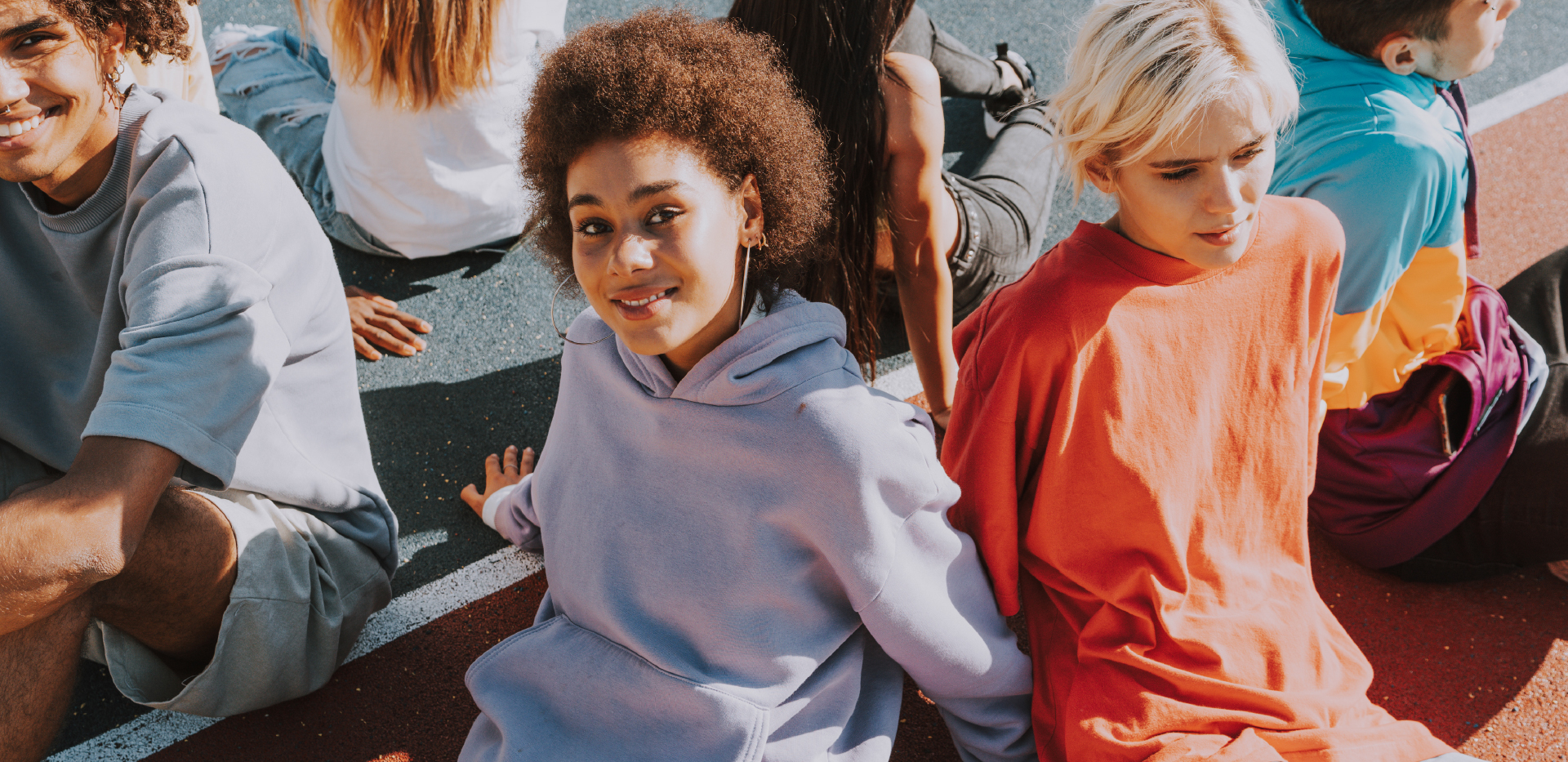 young adults sitting together with hoodies on