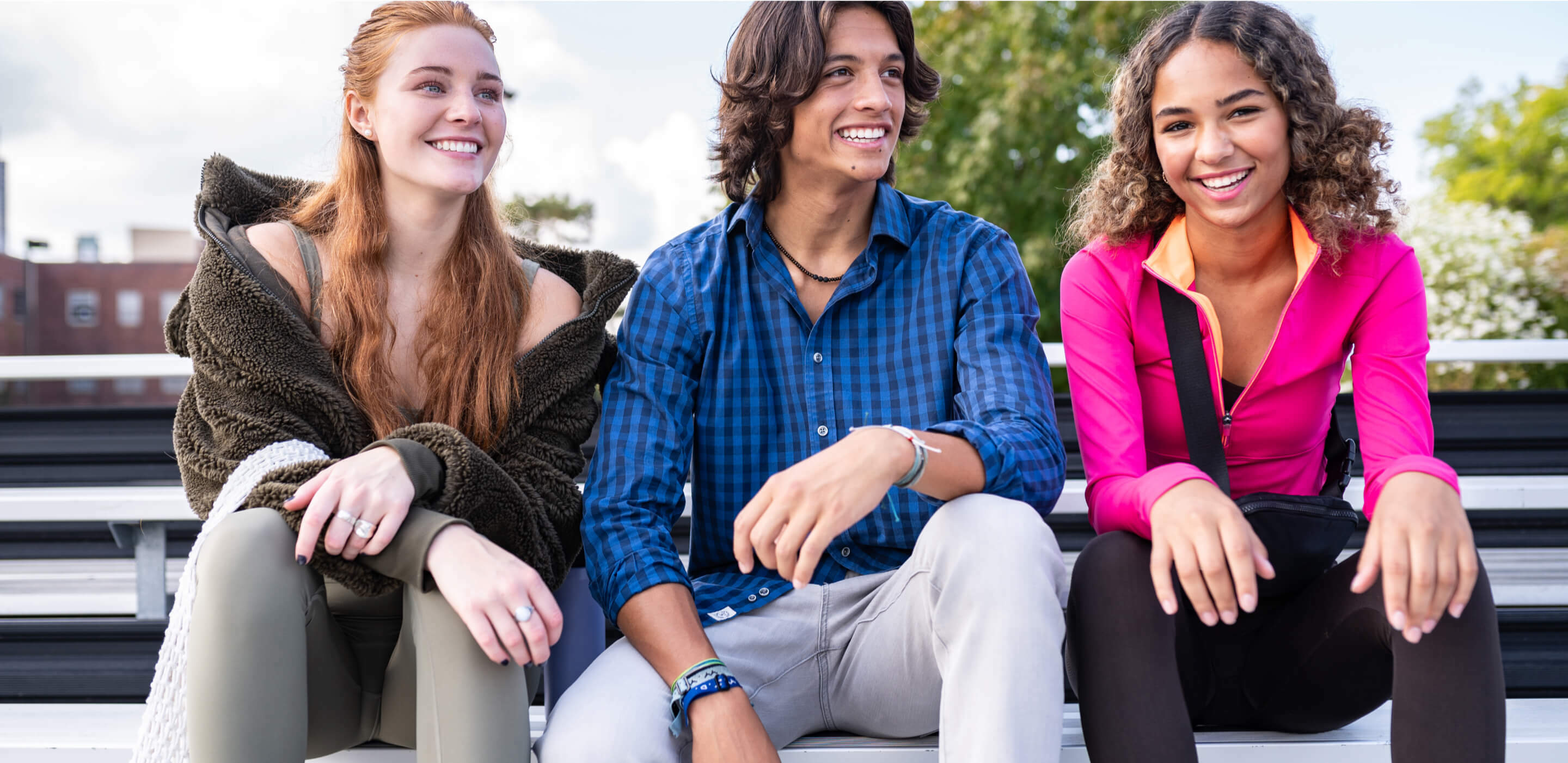 three people sitting on bench