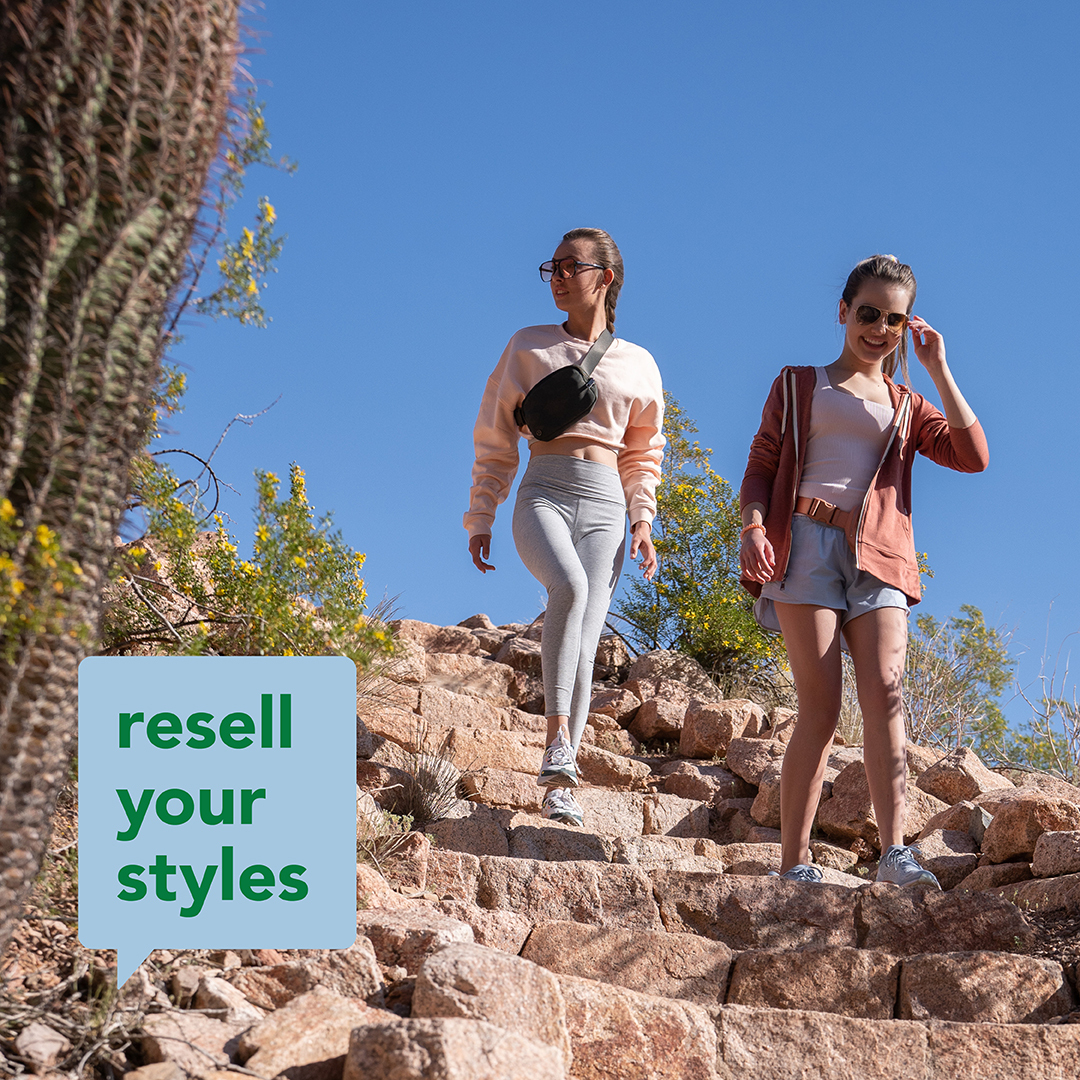 2 girls in athletic wear hiking down a hill