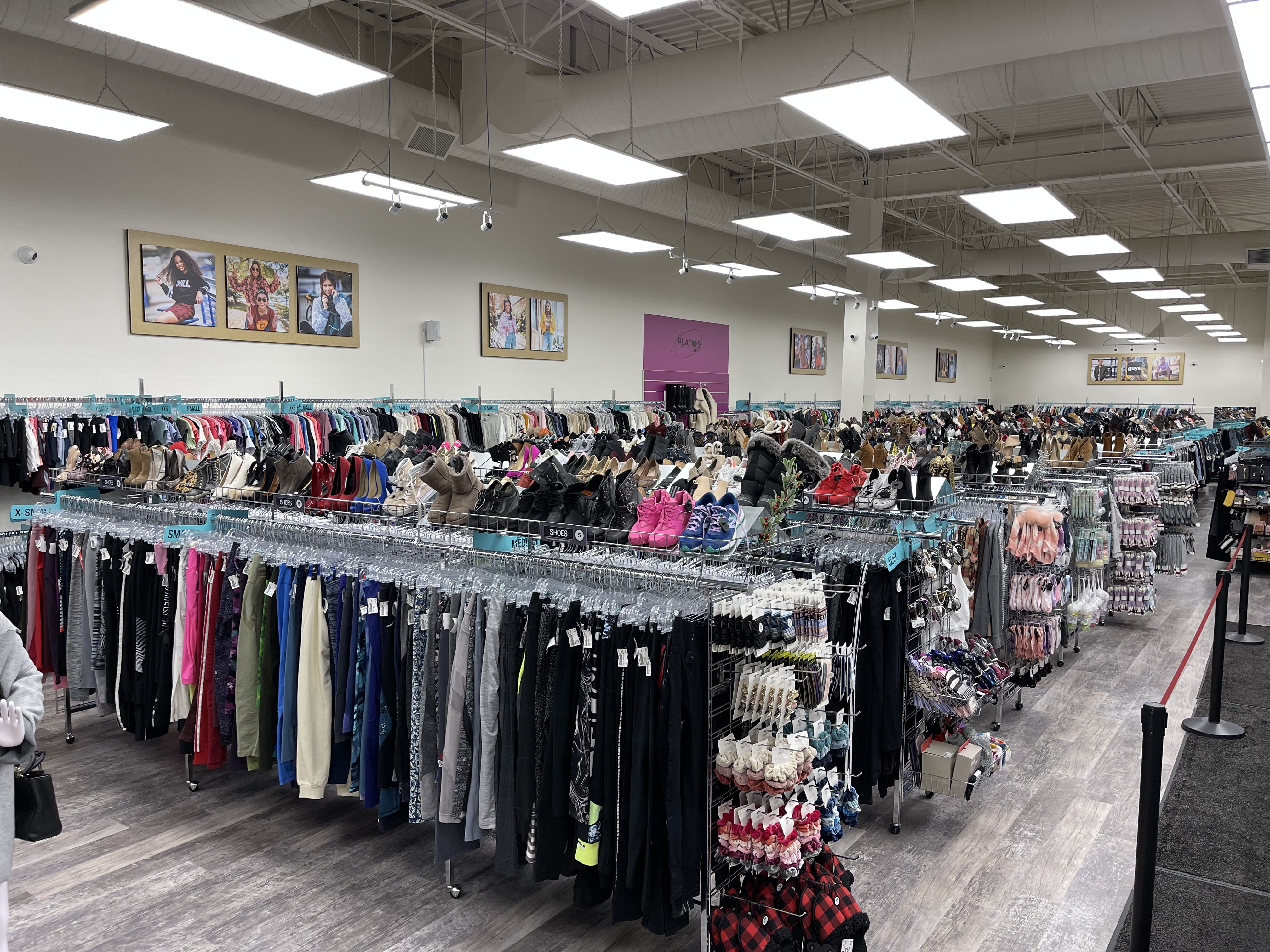 Picture of Plato's Closet Windsor interior, with racks of clothing and shoes.