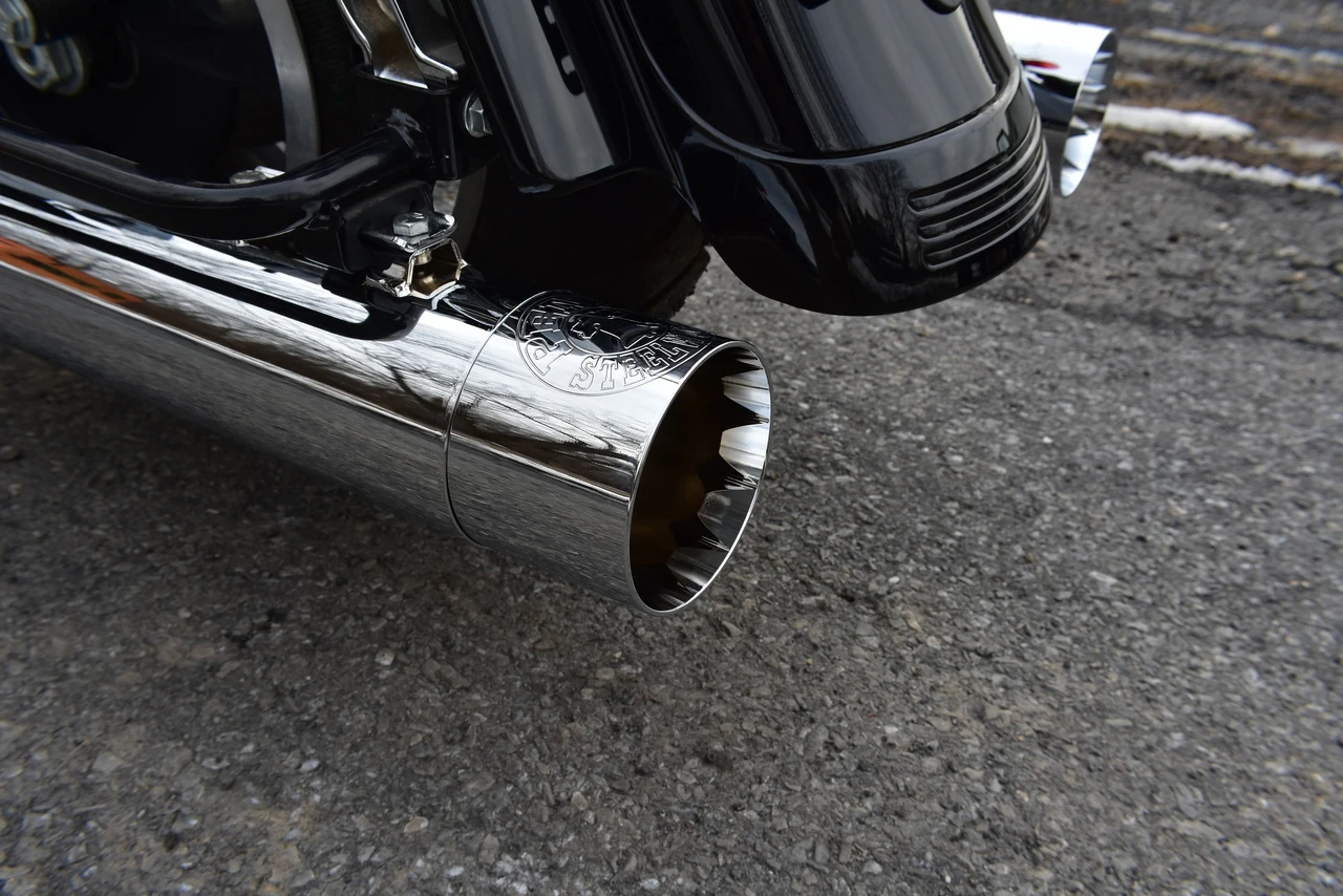 Chrome slip-on muffler installed on a Harley Davidson Touring model