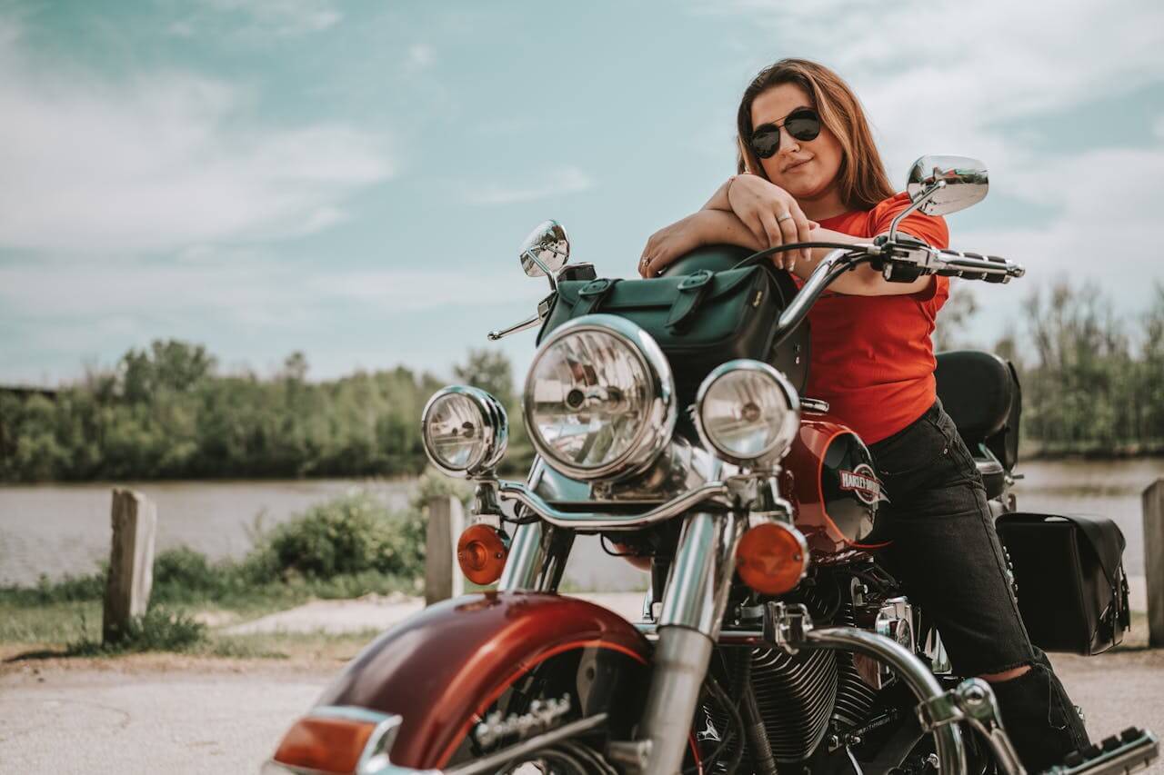 A biker on a motorcycle with leather saddlebags and a trunk