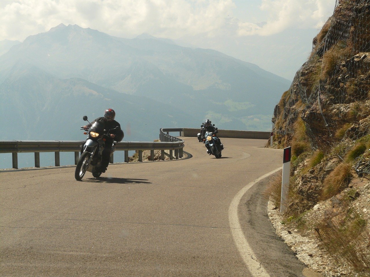 motorcycle riders cruising highway side