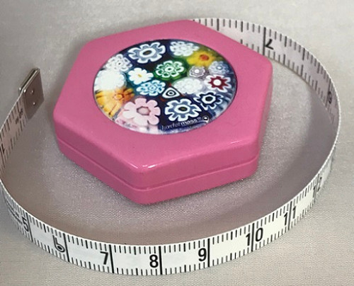 These lightweight, retractable tape measures are perfect for the sewing kit. Magnetic buttons sticks to any metallic surface and retracts easily with a push of a button. 
They are 150cm / 60inches maximum length - inches on one side, centimetres on the other.
Various Designs.