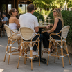Brittany Bar Stool in an outdoor patio or garden area at a restaurant or bistro