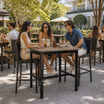 Extrema Planked Vintage Wood 'Textured' - Black Mid Height Table in an outdoor patio setting at a restaurant or hotel