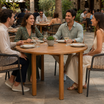 Hardy Dining Table - 110cm Diameter Round in a commercial restaurant or café outdoor patio environment