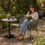 Holt Arm Chair - Dark Grey in a lush garden or patio environment