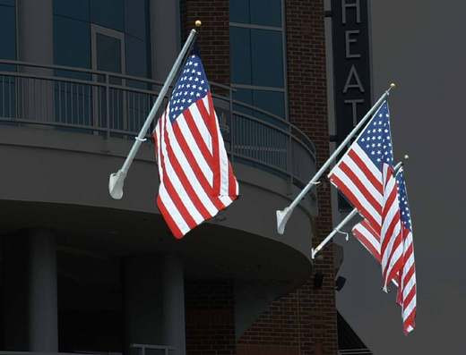 Concord American Outrigger wall mount flagpoles on a building