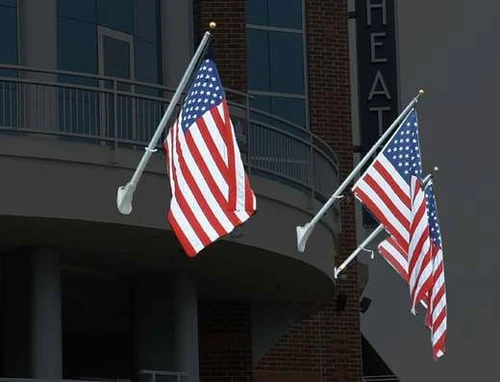 Concord American Outrigger wall mount flagpoles on a building