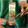 A woman holding a pack of Blazy Susan Tea Leaf Wraps with a rolled joint.