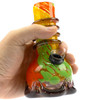 Attaglass 5.5-inch Rasta mini bubble bong held in hand to show compact size and scale