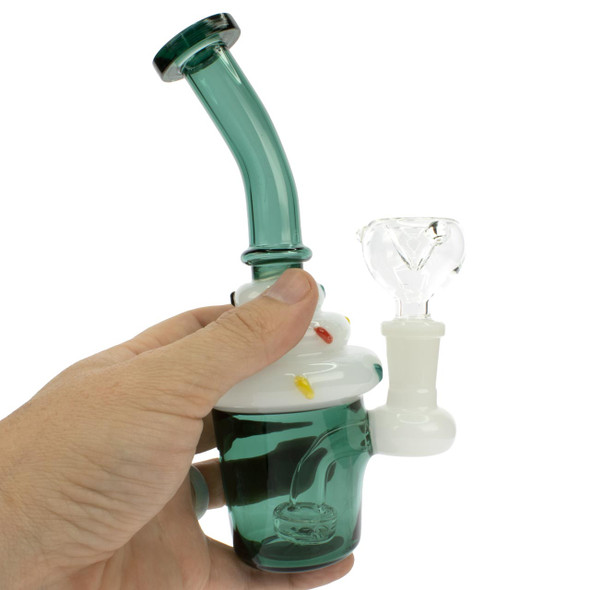 Hand holding teal cupcake bong showing 7 inch size and bent neck design