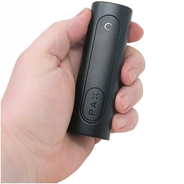 PAX FLOW Dry Herb Vaporizer held by hand.
