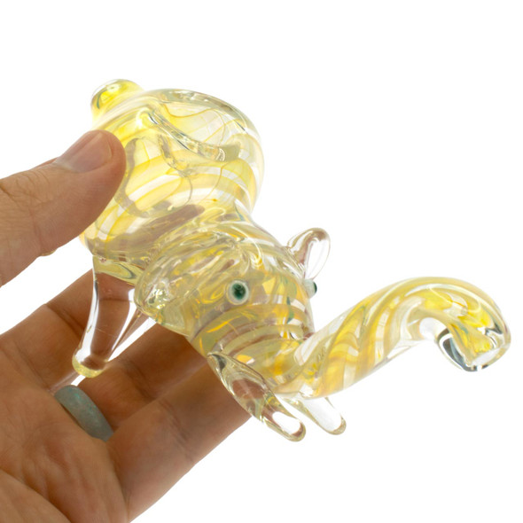 Hand holding small gold fumed glass elephant hand pipe to show size