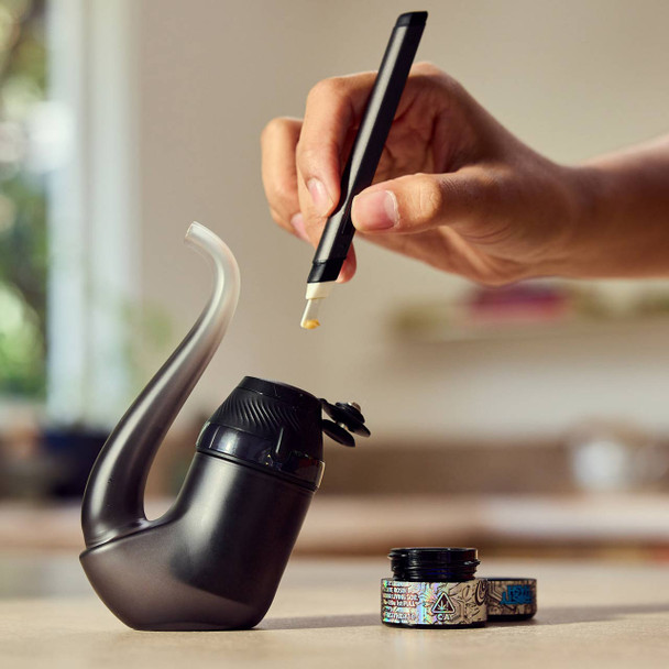 Puffco Proxy Onyx dab vaporizer being loaded with concentrate using a dab tool