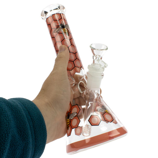 Beehive Glass Beaker Bong with honeycomb and bee pattern held in hand