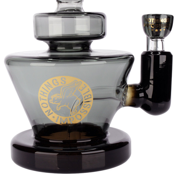 Flying Pig 8-inch black glass water pipe with matching Flying Pig hook bowl, smoke gray borosilicate glass, and sturdy wide base, close up font view of gold leaf logo.