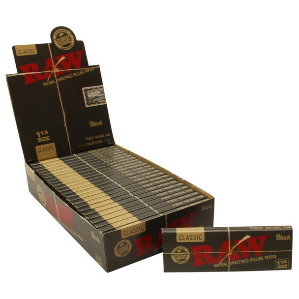 An open Raw Black 1 1/4 display box with a single booklet next to it.