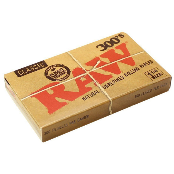 A pack of Raw 300's Classic 1 1/4 Rolling Papers laying at an angle.
