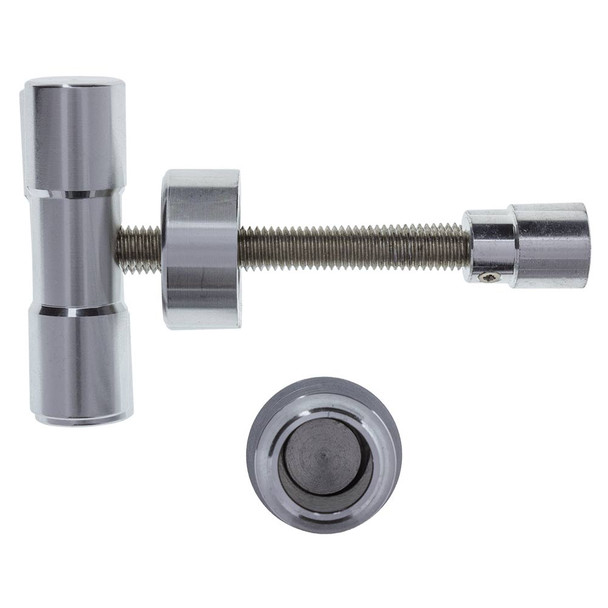 A view into the pressing chamber with the top removed, laying flat next to it.