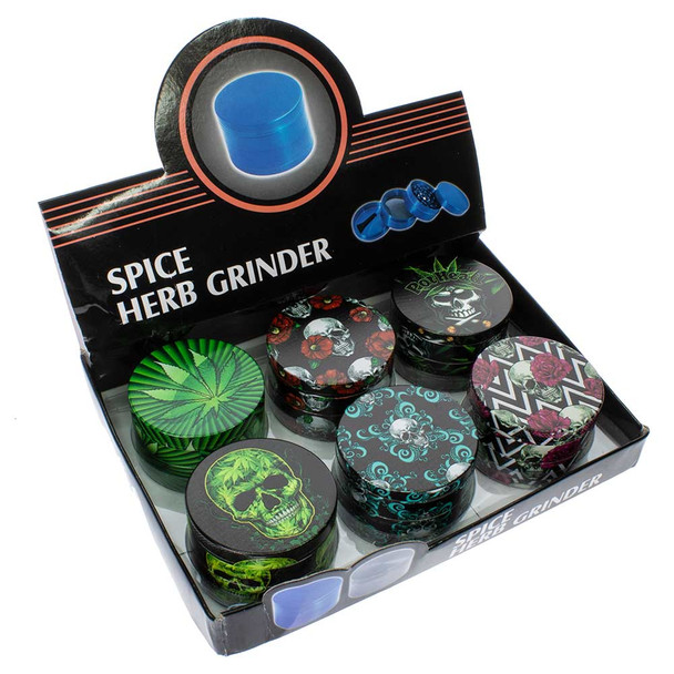 Box of assorted grinders with stoner and skull graphics.