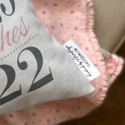 Birth announcement pillow in blush, dark grey and gold floral tag