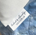 Birth announcement pillow in blue with tag