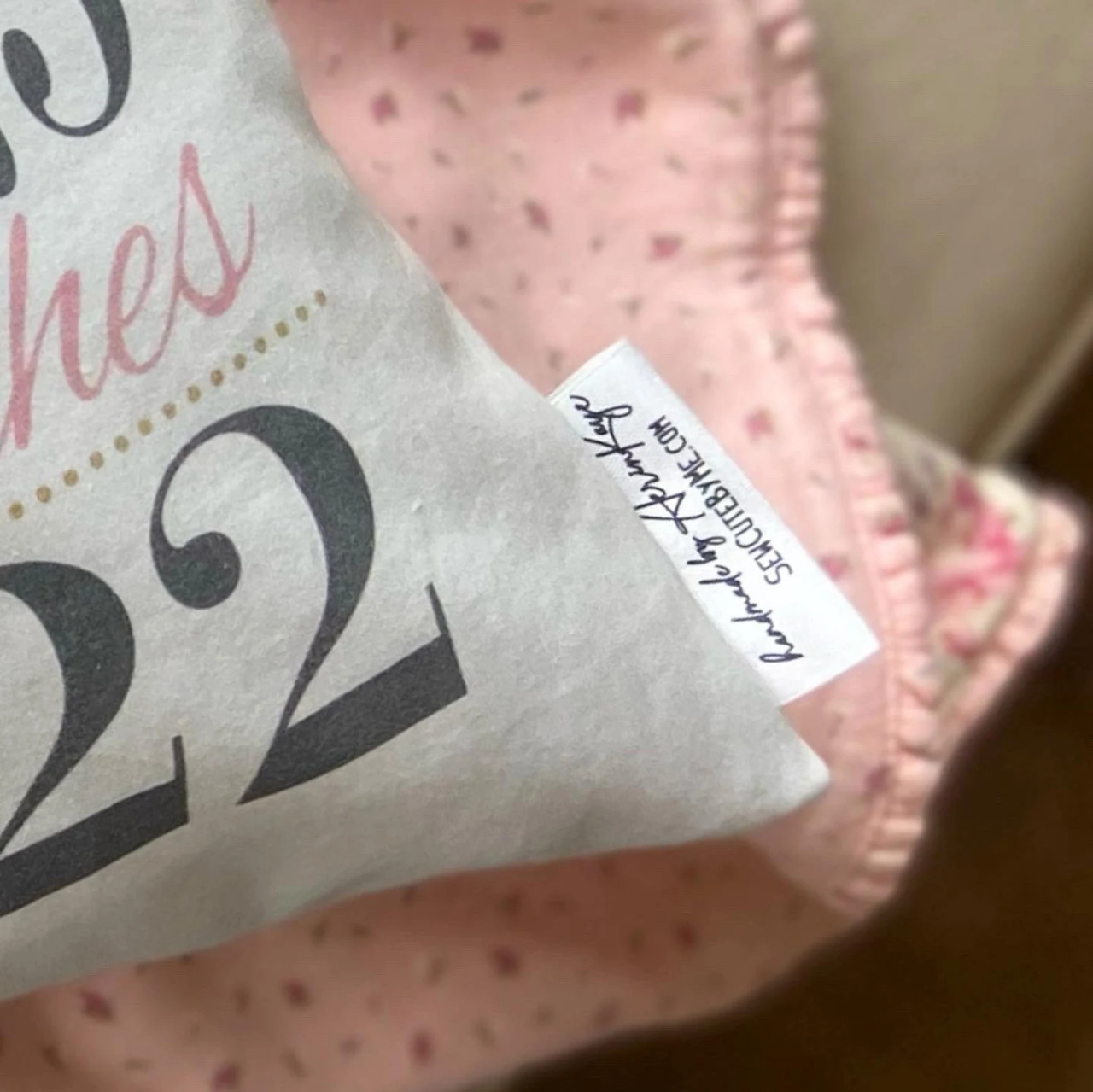 Birth announcement pillow in blush, dark grey and gold floral tag