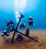 Divers gather near a wreck