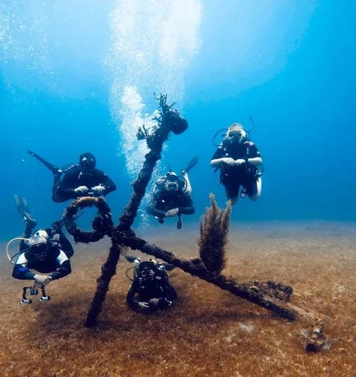 Divers gather near a wreck