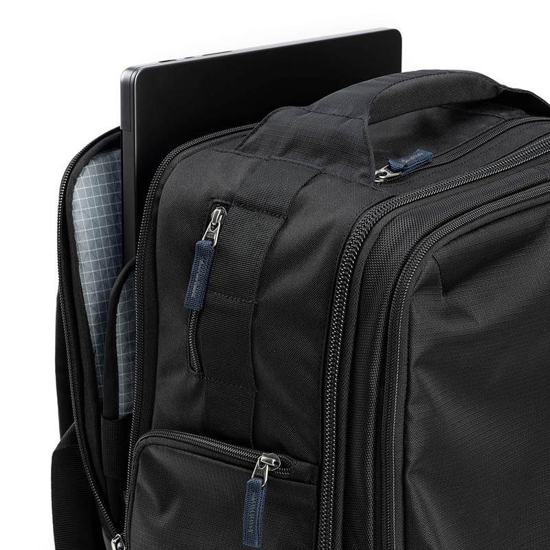 Think Tank Airport Accelerator 41L backpack attached to rolling luggage during photography travel
