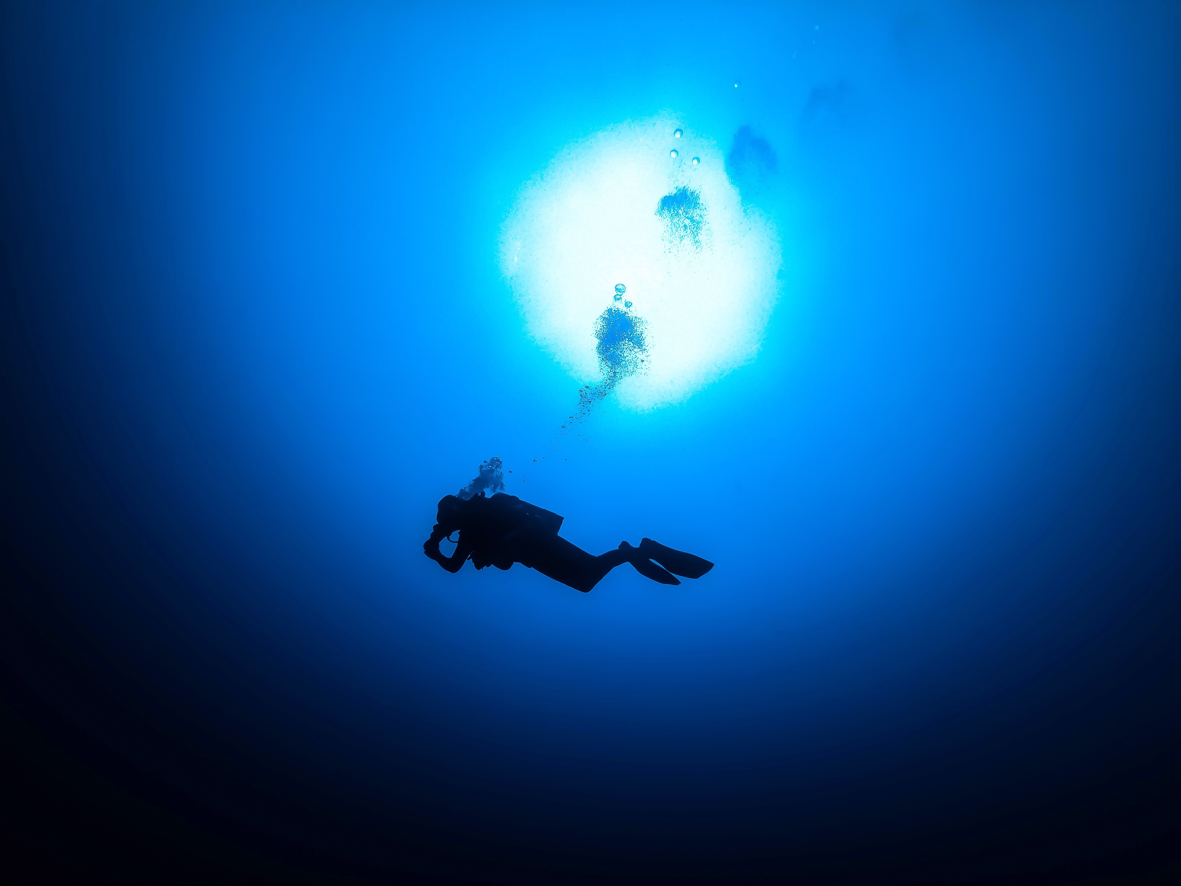 Underwater photographer wearing Garmin Fenix 9 Pro while shooting a reef scene