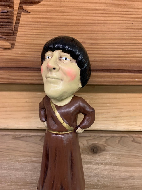 Close up of monk bobble head tap handle top