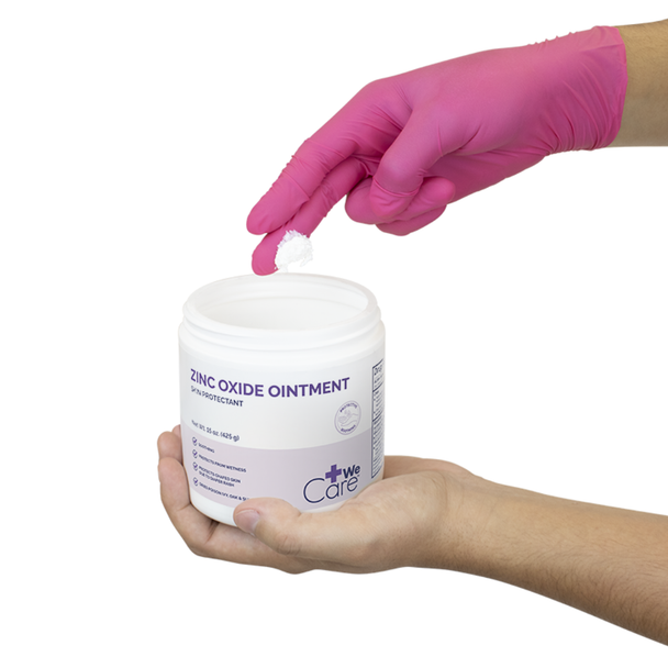 Hand in a pink nitrile glove scooping Dynarex Zinc Oxide Ointment out of the 15 oz jar for clinical or home care application.