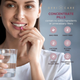 Smiling woman holding a glass of water, preparing to take her daily Geri-Care Cranberry supplement tablet.